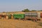 John Deere tractor pulling grain wagons