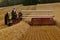 John Dere tractor and swather harvesting wheat