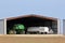 Johndeere Combine and wheat trucks in a garage on a farm north of Lyons Kansas.