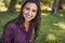 Joifyl attractive shot of happy young brunette Caucasian female smiling and wearing plaid shirt against nature background in the