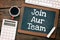 JOIN AUR TEAM written on a chalkboard. Concept in business