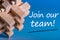 Join our team - message at blue background near macroviewed brain teaser. Hiring and new job concept