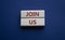 Join us symbol. Concept word Join us on wooden blocks. Beautiful deep blue background. Business and Join us concept. Copy space