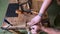 Joiner cuts cuts in an oak board with a tongue-and-groove. carpenter works with combination plane. view from above