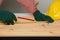 Joiner measuring a wooden plank with tape measure yellow on the work-table for construction