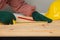 Joiner measuring a wooden plank with tape measure yellow on the work-table for construction