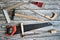 Joiner tools on wooden background. Handsaw, hammer, set square, chisel, ruler, hand drilling tool