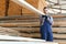 Joiner in uniform check boards on timber mill