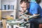 Joinery: furniture master restores the old, dilapidated stool. Closeup of a man`s hand.