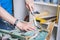 Joinery: furniture master restores the old, dilapidated stool. Closeup of a man`s hand.