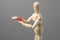 Joint pain forearm. The wooden man is holding his hand over his forearm in red