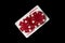 Joker card and red chips in the black background. Winning combination at a poker club or casino. Free advertising space