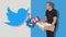 Joking editorial illustration of Elon Musk holding a shell and Twitter logo