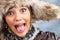 Joking woman with fur hat, close up portrait