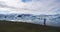 Jokulsarlon glacial lagoon lake in Iceland Amazing Icelandic nature landscape. Woman tourist hiker walking