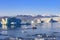 Jokulsarlon glacier lagoon in Iceland. Blue icebergs and tour boat on lake water. Northern nature landscape in Vatnajokull