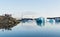 JOKULSARLON, ICELAND - AUGUST 2018: people taking pictures of iceberg in the water of Vatnajokull glacier lagoon