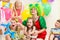 Jolly kids with clown on birthday party