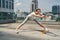 Jolly mature woman training flexibility on roof