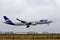 Joon Airbus A340-313 landing at Paris CDG