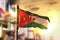Jordan Flag Against City Blurred Background At Sunrise Backlight