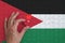 Jordan flag is depicted on a puzzle, which the man`s hand completes to fold