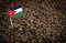 Jordan flag sticking in roasted coffee beans. Concept of export and import