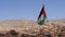 Jordan flag waving in the air on a sunny and windy day in Petra landscape Jordan