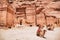 Jordan travel background with camels in front of monastery ruins in Wadi Rum desert. Nature landscape