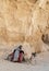 A Jordanian Camel Guide using his cell phone with camel at Petra, Jordan