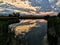 Josh`s Pond in Broomfield Colorado at Sunset reflecting off water, Rocky Mountains in the background