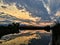 Josh`s Pond in Broomfield Colorado at Sunset reflecting off water, Rocky Mountains in the background