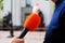 The journalist holds a red microphone in his hand and interviews on the street. Television reporter with microphone at  mass event