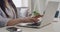 Journalist typing a story on a laptop and working from home. Closeup of hands of a news reporter writing a blog post for