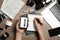 Journalist with voice recorder working at wooden table