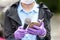 Journalist wearing protective gloves and face mask against coronavirus COVID-19 disease holding microphone making media interview