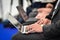 Journalists hands typing on laptops during a press conference