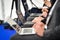 Journalists hands typing on laptops during a press conference