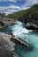 Journey to Norway, stormy blue, clear and transparent river flows among stones and woods