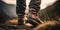 Journey to the Summit. Close-up shot of worn leather hiking boots trekking up a rocky mountain trail showcasing the rugged terrain