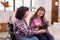 Jovial disabled woman and girl examining VR headset