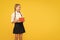 The joy of good knowledge. Cute small girl holding book on yellow background. Adorable little schoolchild getting