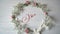 Joy Vintage Written animation word on round wreath with branch on white wooden background. Calligraphy and lettering