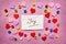 Joy - word on pink background with colorful hearts decorations