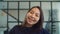 Joyful adorable young asian woman smiling indoors