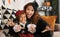 Joyful african american family mother and little boy son in Halloween costumes making scary gesture