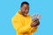 Joyful African American Guy Shouting Holding Euro Money, Blue Background