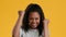 Joyful African Teen Girl Gesturing Yes Celebrating Success, Yellow Background