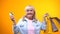 Joyful aged woman showing shopping bags and bank card, services for retirees