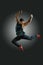 Joyful athletic build man jumping on air on a black background. Lifestyle and sport concept